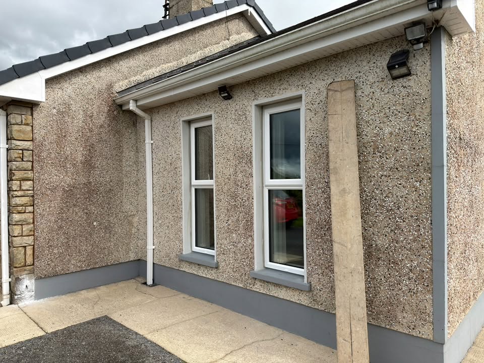 Replacement windows on a pebble-dash home by CT Improvements